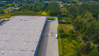 Aerial view of goods warehouse. Logistics center in industrial city zone from drone view.