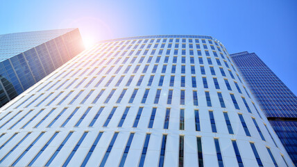 Bottom view of glass silhouette of skyscraper. Business building. Skyscraper with glass facade. Modern building in business district. Concepts of economics, financial, future. 