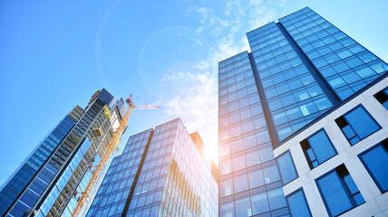 Obraz premium High-rise building under construction. Modern office building. Sunset.