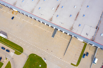 Aerial view of storage and freight terminal with trucks and containers. Industrial background. Logistic center.