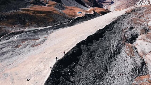 Thorong La Pass-Nepal. Trekkers walking across mountain ridge.