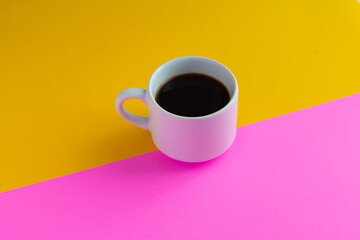 cup of coffee with yellow and pink background