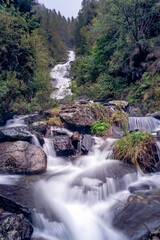 Fototapeta na wymiar The beautiful waterfalls formed by the torrent of Sambuzza valley - Orobie - Italian Alps