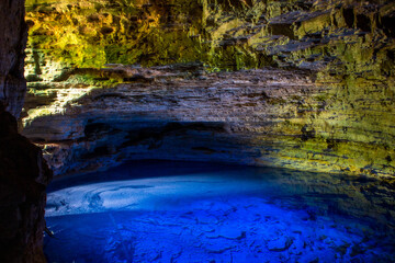 Colorful cave with transparent blue water