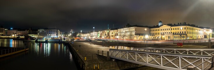 A beautiful city night skyline of downtown Helsinki with the Finnish presidential palace and market square in the foreground.