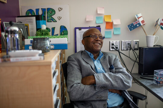 Teacher Sitting In Office Smiling