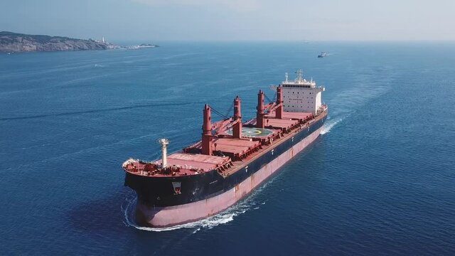 Flying over a cargo ship cruising northbound on Straits Bosporus. A bulk carrier or bulker is a merchant ship specially designed to transport unpackaged bulk cargo, such as grains, ore, coal or timber