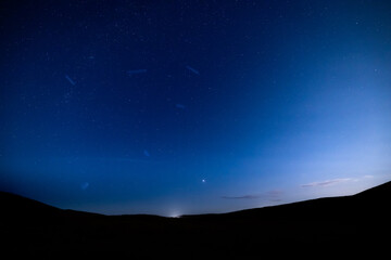 night shot of the stars and Milky Way above rannoch moor, glen etive and Glencoe in the argyll region of the highlands of Scotland during a clear bright night in autumn