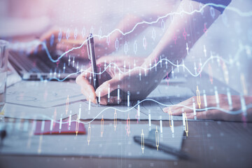 Multi exposure of woman hands typing on computer and financial chart hologram drawing. Stock market analysis concept.