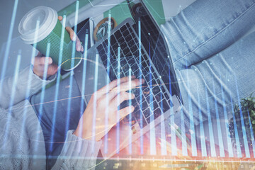 Double exposure of woman hands typing on computer and forex chart hologram drawing. Stock market invest concept.