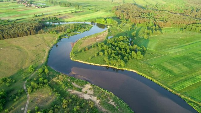Aerial view of natural meandering river during spring