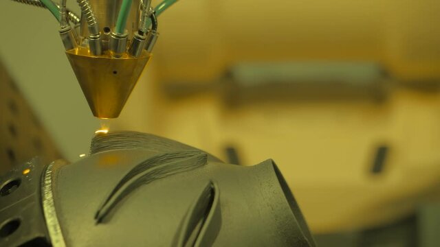 Metalworking, robotic, industrial concept. Direct metal deposition - advanced additive laser melting and powder spray manufacturing technology for repair, rebuild metal workpieces - slow motion