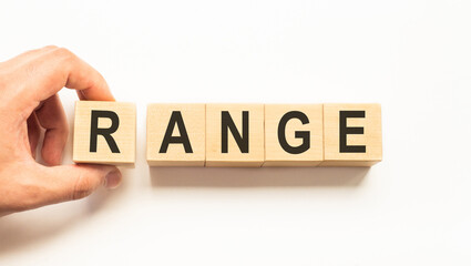 Word range. Wooden small cubes with letters isolated on white background with copy space available.Business Concept image.