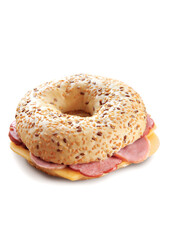 A tasty bagel with ham, cheese and seeds, isolated