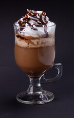 a glass of cappuccino with cream