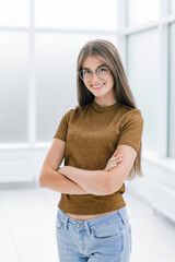 smiling young woman standing in bright office .