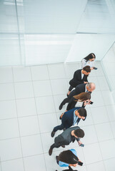 top view. a group of business people looking at their smartphon screens.