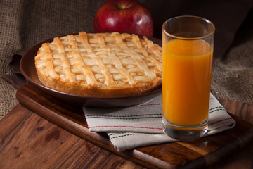 A delicious homemade apple pie with a glass of juice