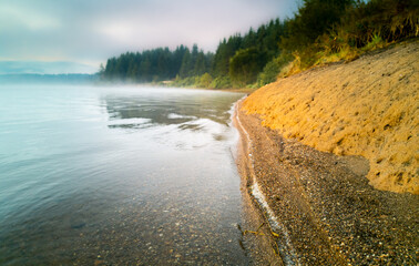 Waves on the lake in the foggy morning. 