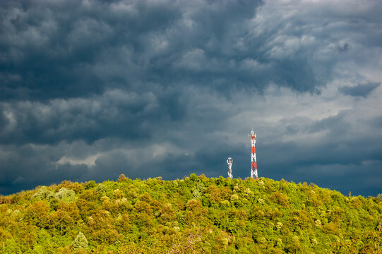 Cell Tower On Top Of The Hill With Storm Clouds Coming In