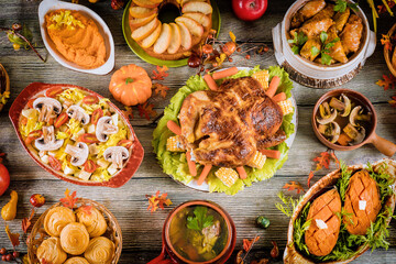 Thanksgiving holiday table served with turkey and a lot of food.