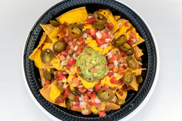 Overhead view of hearty meal of vegan nachos tempts the taste buds to eat the entire meal.