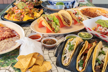Table full of difficult choices of Mexican grilled meals to choose from.