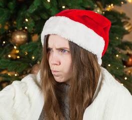 The girl in Santa's hat with a dissatisfied look. She does not love Christmas.