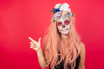 Young beautiful woman wearing halloween make up over red background pointing up with fingers number eight in Chinese sign language BÄ.