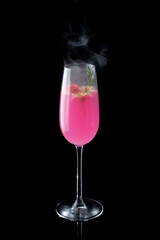 Pink cocktail with smoke on the black background