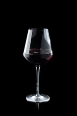 Glass of red wine on the black background