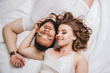 Guy and a girl in a cozy home environment. Top view of smiling couple