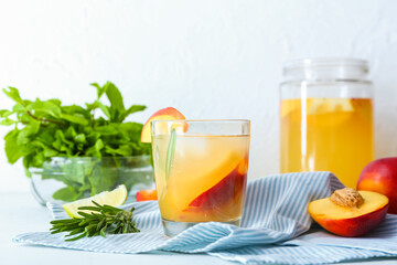 Composition with fresh peach lemonade on table