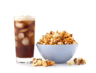 Tasty popcorn and cola on white background