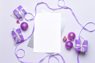 Beautiful Christmas gifts with empty card on light background