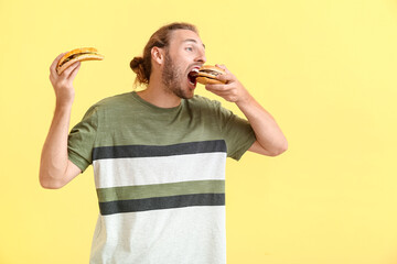 Man with problem of strong hunger on color background. Diabetes symptoms