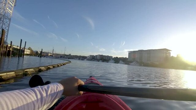 Man Paddling Kayak At Thea Foss Waterway On A Sunny Day In Tacoma, Washington, USA.  - POV - wide shot
