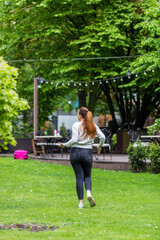 A woman walks in the spring in the park.