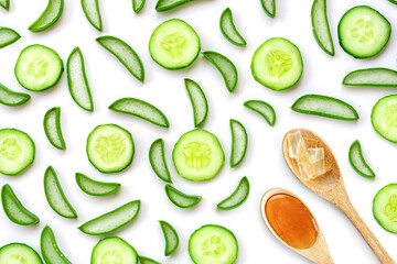 Green fresh aloe vera slice and cucumber with honey on white background. Top view. Flat lay.