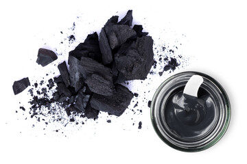 Activated charcoal powder and Clay or charcoal mud cream in jar isolated on white background. Top view. Flat lay. Beauty spa, skin care, natural face mask concept.