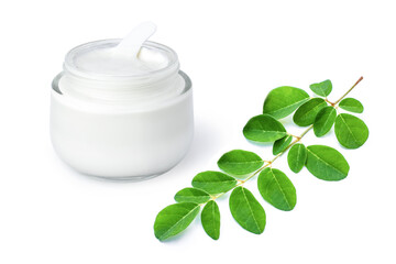 Moringa beauty cosmetic cream lotion in glass jar and green moringa Oleifera leaf ( Horse radish or Drumstick )  isolated on white background . Skincare, beauty and spa concept. 