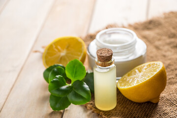 Health care concept. Organic cosmetics with lemon. Product for spa and aromatherapy. Natural moisturizer on wooden background.