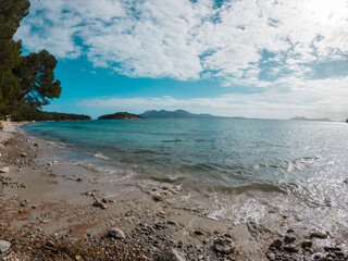 Beautiful virgin beach, withe blue water and mediterranean trees in Mallorca, Europe, Spain.
