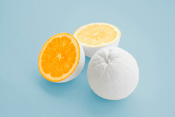 citrus orange painted white on baby blue background