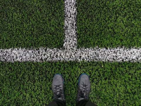 artificial turf and white line close-up and athlete's feet, selective focus, background image