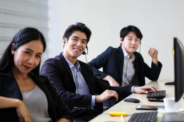 Asia Group of call center workers or Confident business team with headset in office.