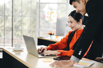 Adult asian business women and man working in office on day.