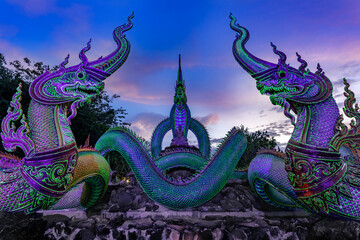 A glowing serpent statue with Twilight at Wat Pa Phupang  temple Si Chiang Mai District, Ubon...