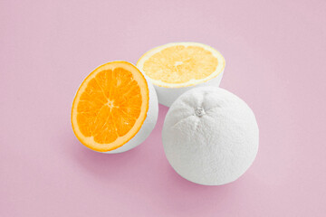 citrus orange painted white on pale pink background 
