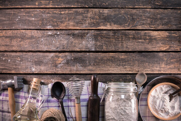 Old rural kitchen utensils on the old wooden rural table background with copy space.